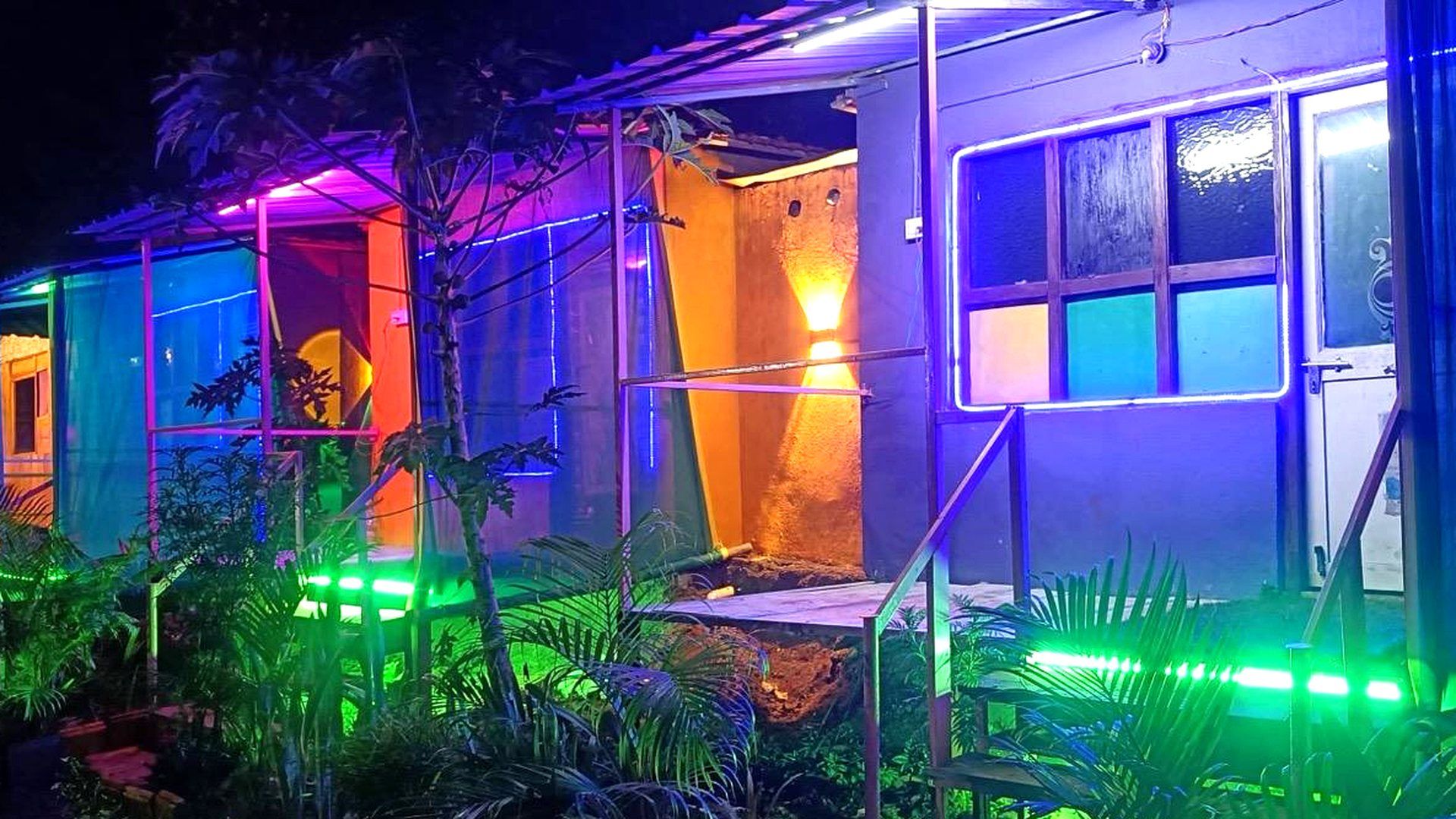 Rayudu Resort's cottages lit up at night